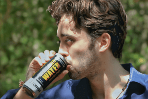 Can of CEHub Premium Sparkling Water drinking by a tourist